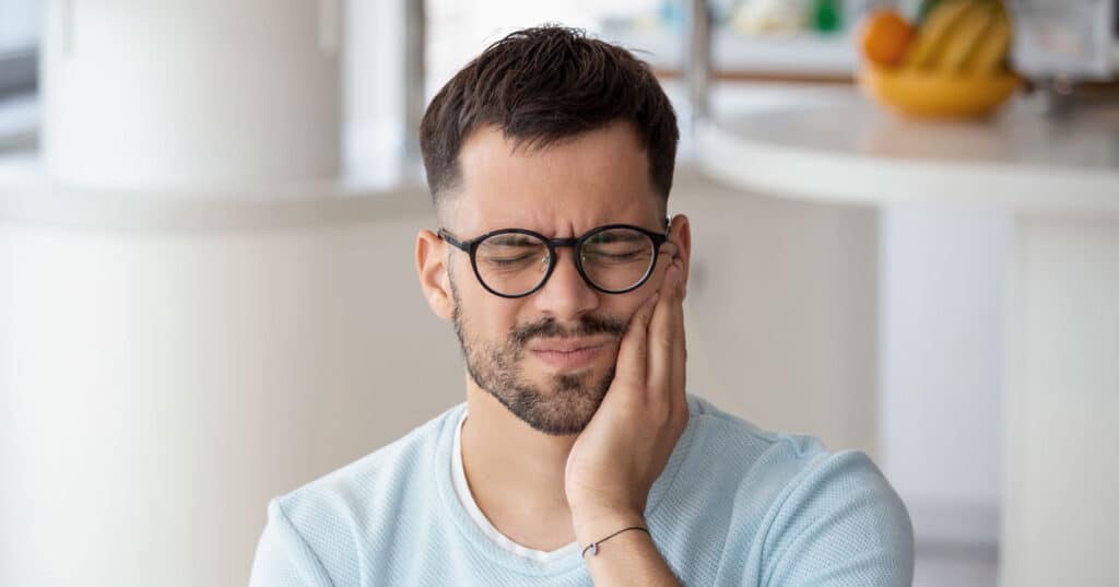 dangers of illegal tooth whitening man in pain