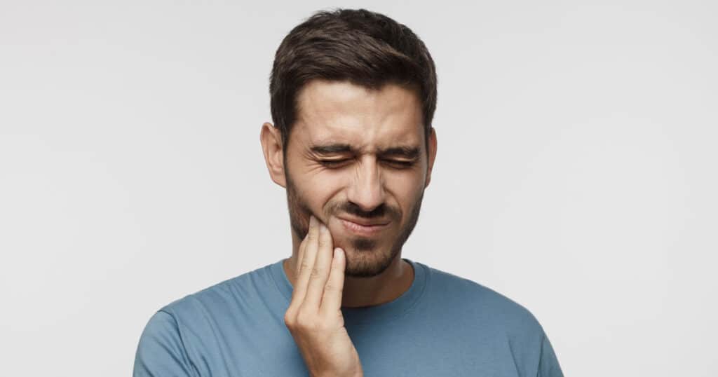 man tooth hurting gum disease
