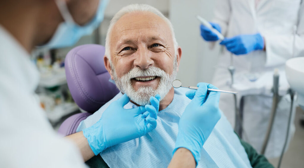 man at dentists getting treatment with dental finance
