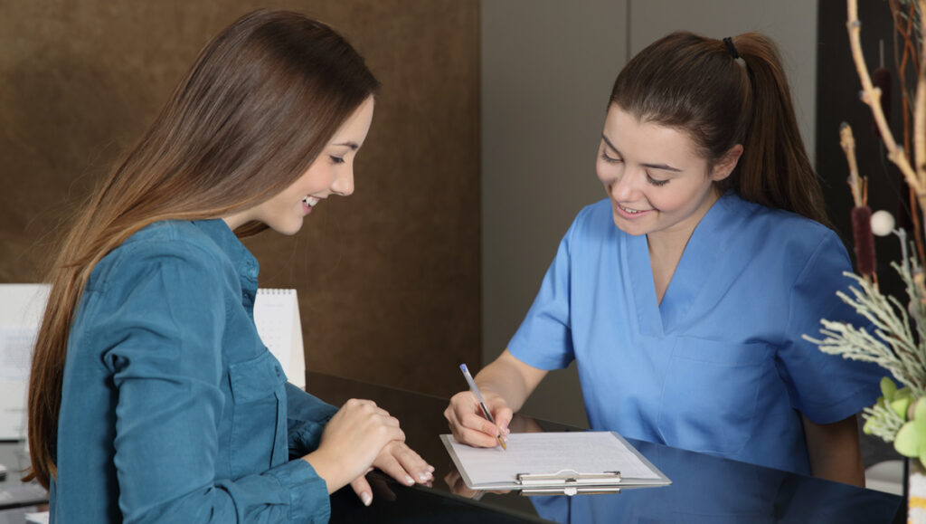 woman at dental reception costs and value of a fulham orthodontist