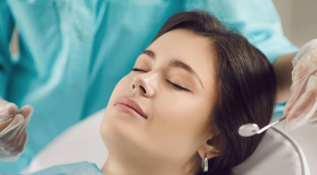 woman comfortly in dentists chair for scale and polish