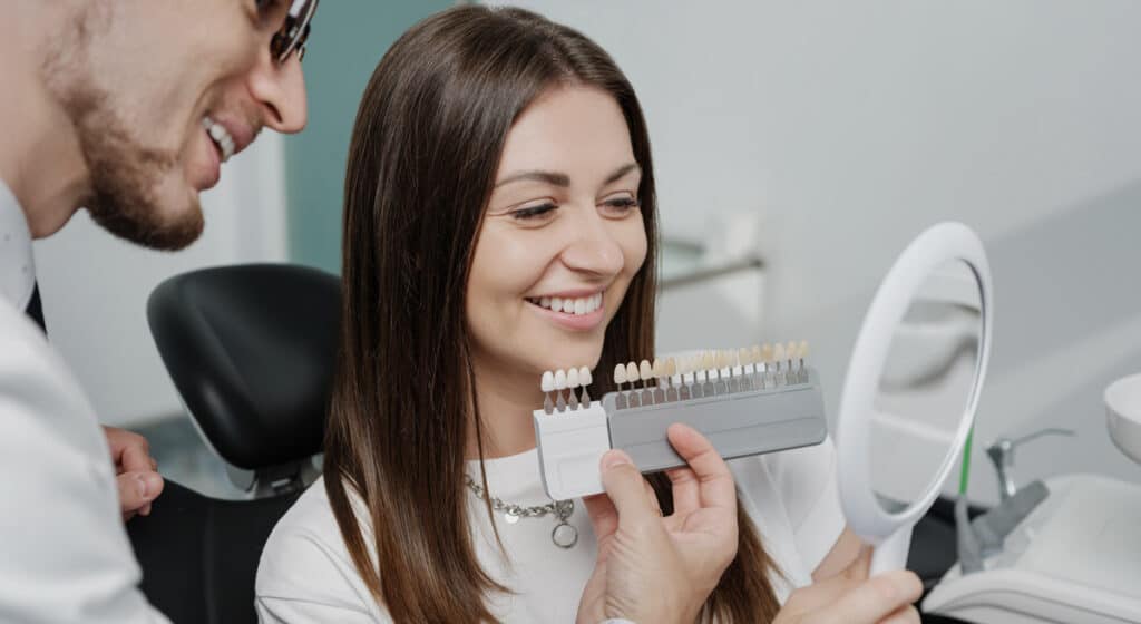 woman at dentists with veneers alternative to crowns for teeth