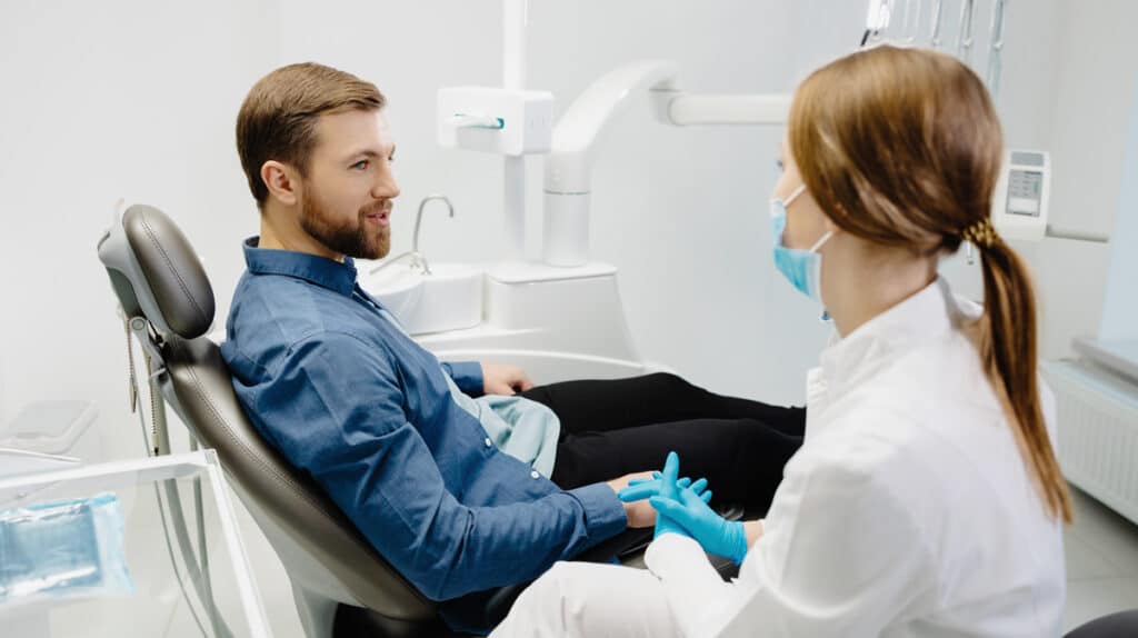 man sat in dentists chair supportive approaches for patients with a fear of the dentist
